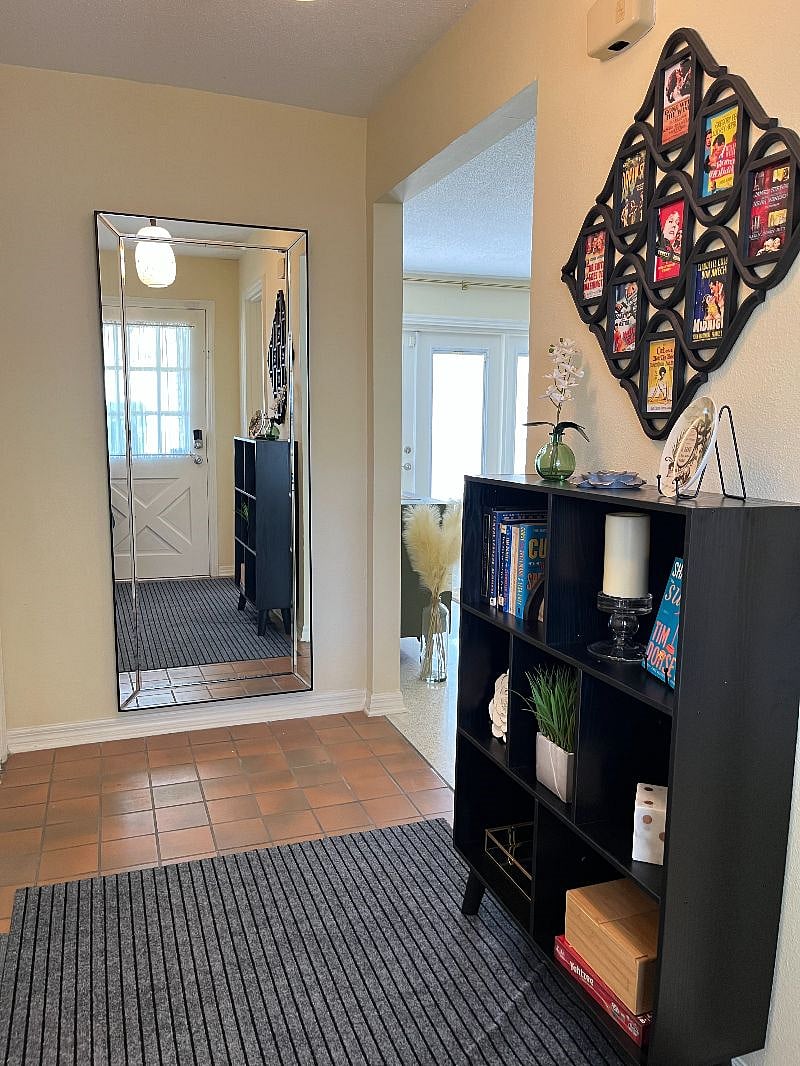 Step through the front door and you are greeted with a aray of choices. Grab a book, choose a game, or peruse the vintage movie posters that served as the inspiration for our home. The full-length mirror allows for a final check as you are running out the door.