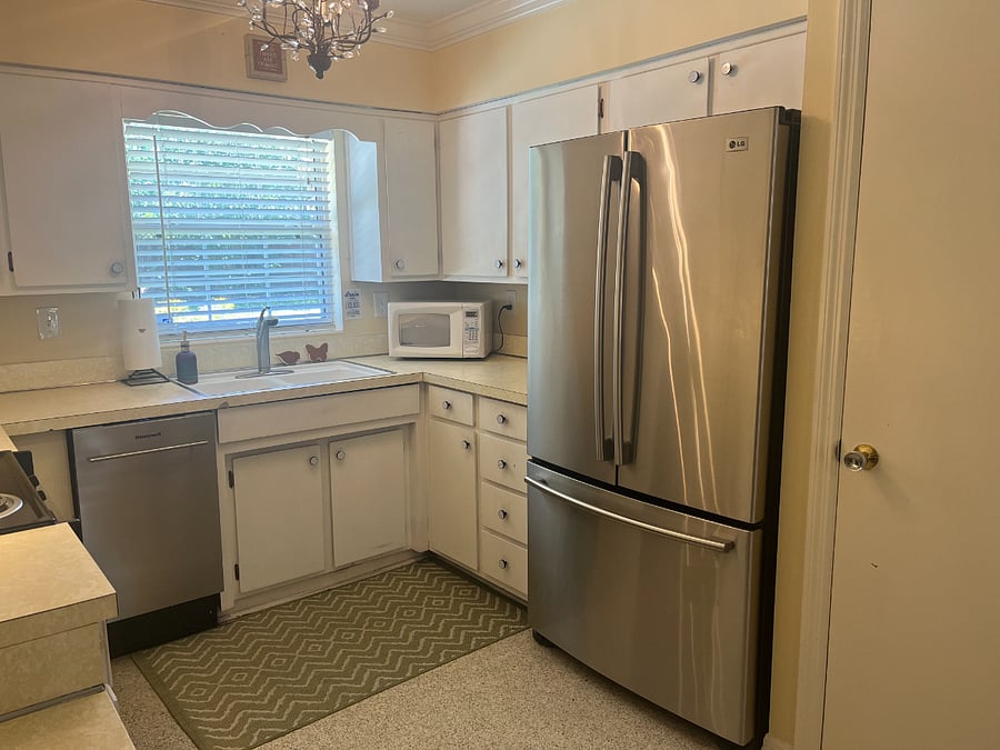 There are so many cabinets, you won't run out of space. You also have a pantry, bar for seating, and beautiful views of the backyard.