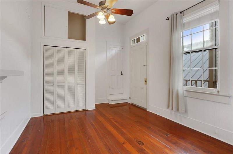 Bedroom before being furnished so you can see the private entrance, beautiful floors, closet, and oversized window!