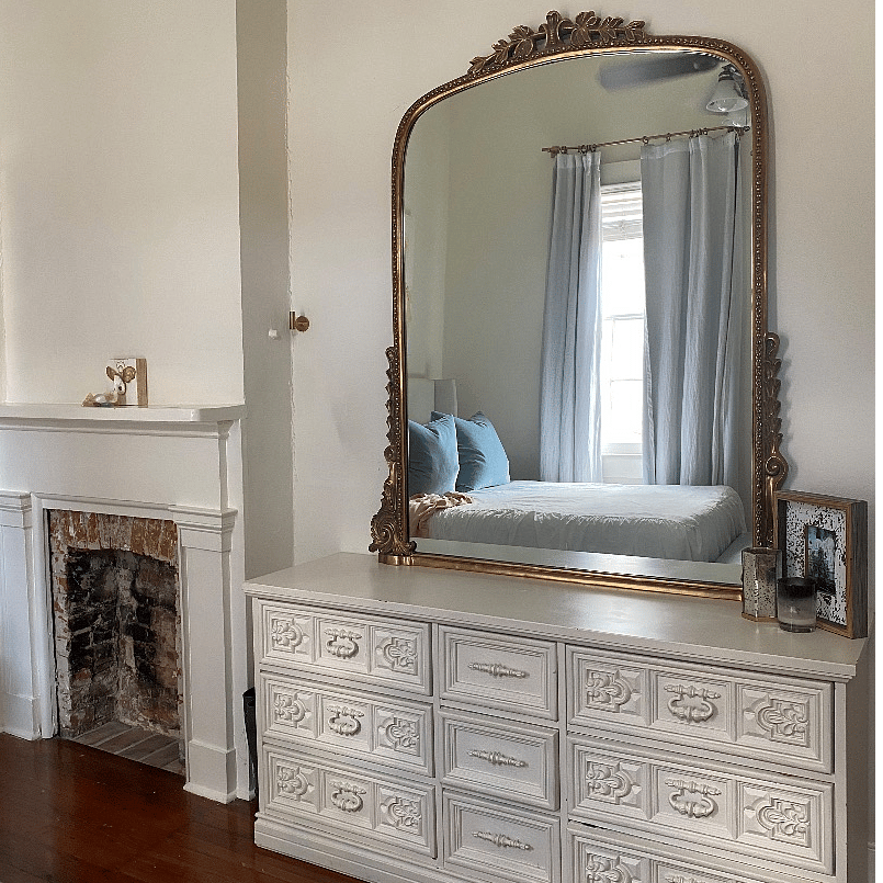 Charming fireplace facade upon entering the room