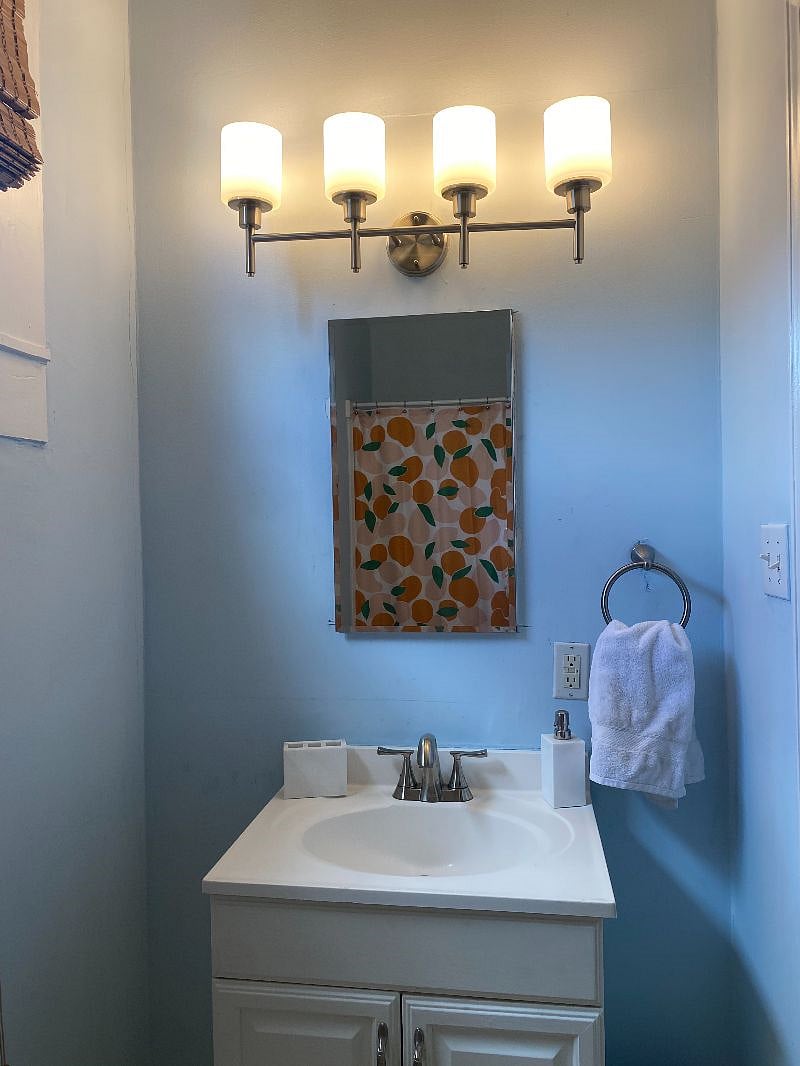 The bathroom is off of the kitchen.