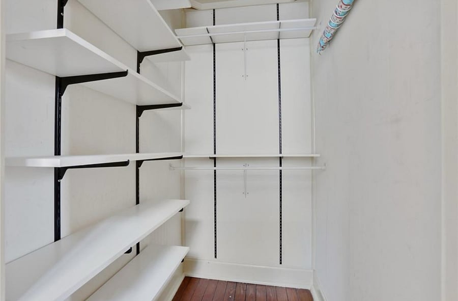 Primary bedroom walk in closet 