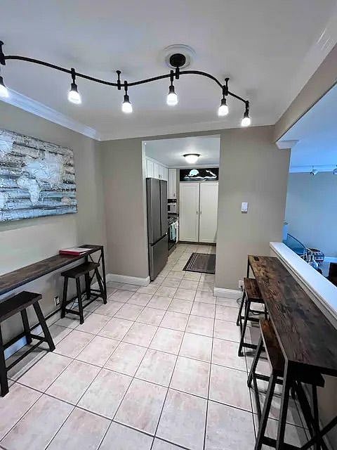 Dining room with new kitchen appliances in view.