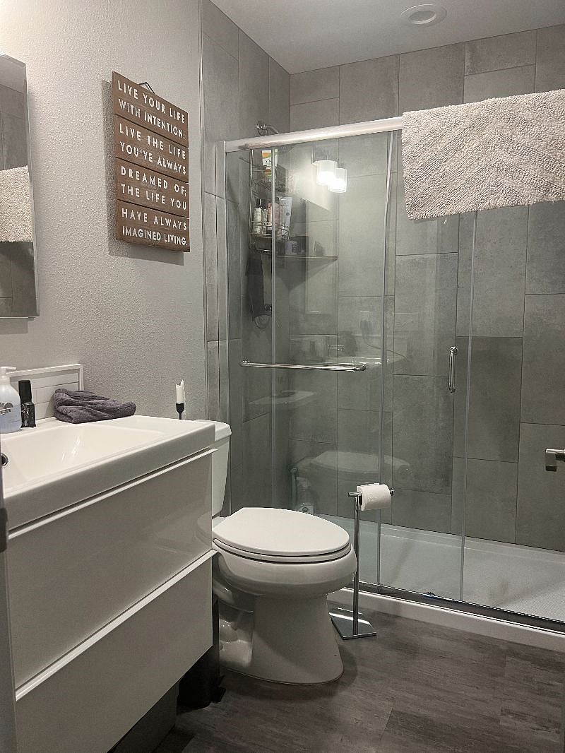 bathroom with glass door tile shower
