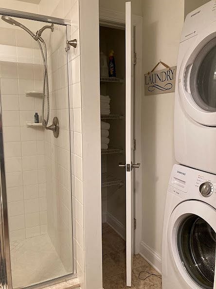 Stacking washer/dryer located in the full bathroom.