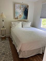 Queen bed, closet, window overlooking the deck.