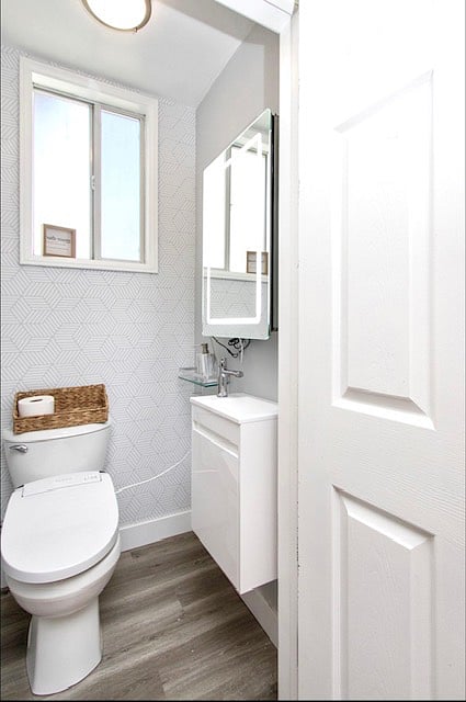 Master bathroom: Toilet with bidet, sink, mirrored medicine cabinet.