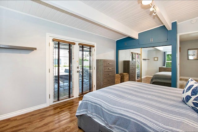 Master bedroom: 1 king bed, 2 dressers, French doors to backyard.