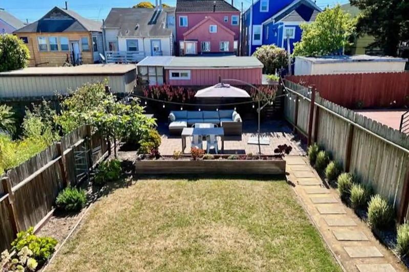 Large backyard with lawn and succulent garden. Great for relaxing!