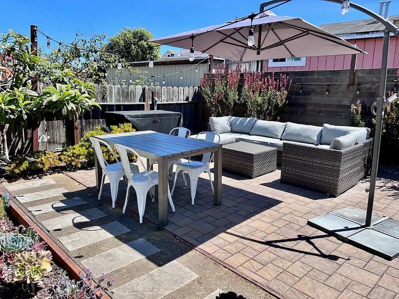 Enjoy outdoor dining in the patio garden. Furnished with seating and dining area and umbrella. Electrical outlets are available and yard is wifi-accessible.