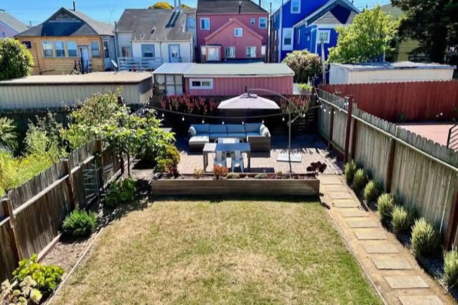 Large backyard with lawn and succulent garden. Great for relaxing!