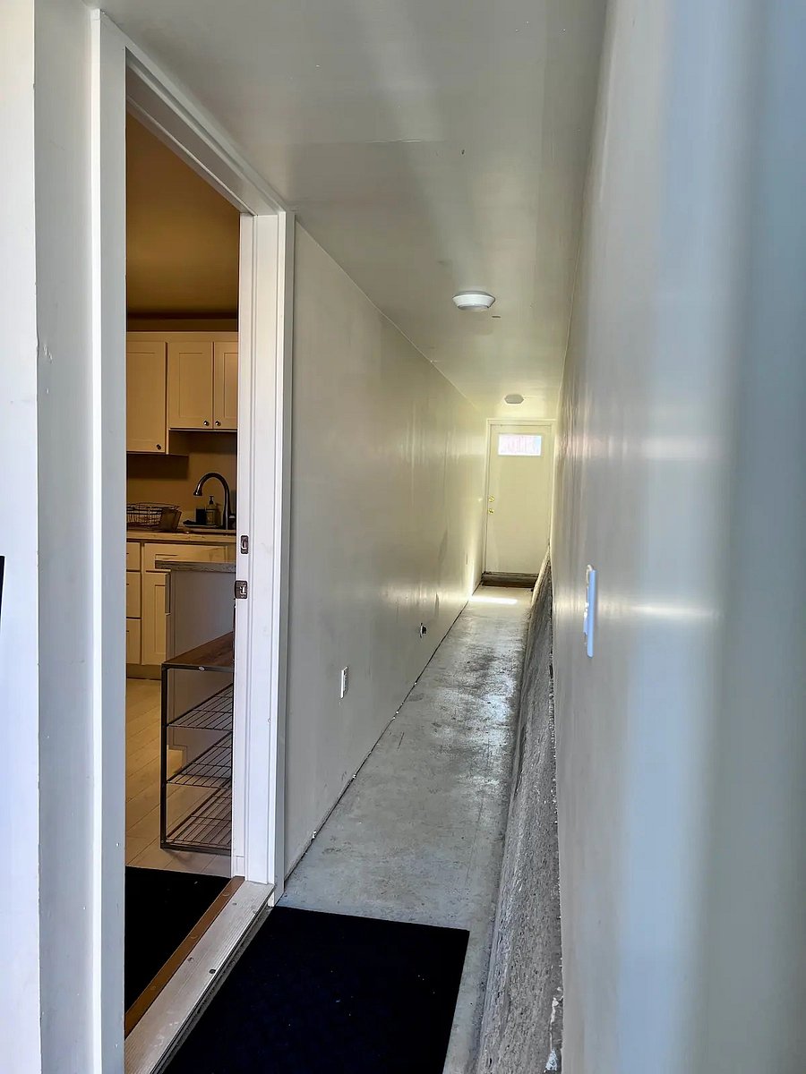 Entrance to the private guest suite on the ground floor, next to the garage with washer & dryer. Access to the backyard is down the hallway.