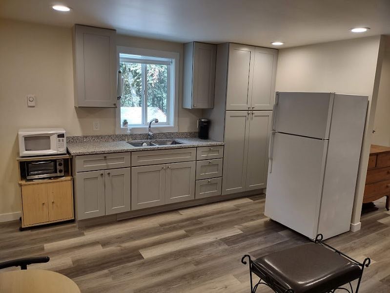 Kitchen fully equipped w/ full size fridge, microwave, toaster oven, air fryer, hot plate, George Foreman grill, crock pot, blender & toaster in addition to a Weber BBQ/grill (propane) for easy meal prep. Keurig & drip coffee options. Granite countertops & large double sink with pullout faucet, lots of cabinet space & large pantry.