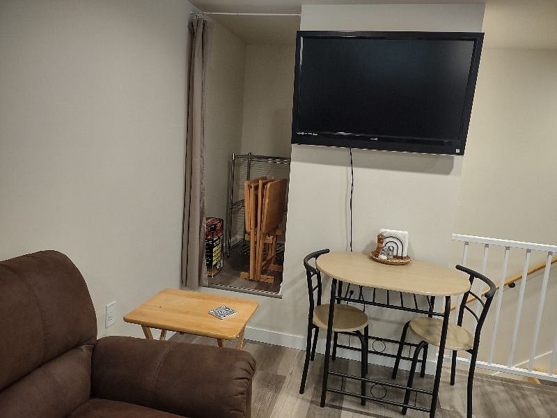 Note the wine rack under table top & storage closet behind the curtain next to the TV!