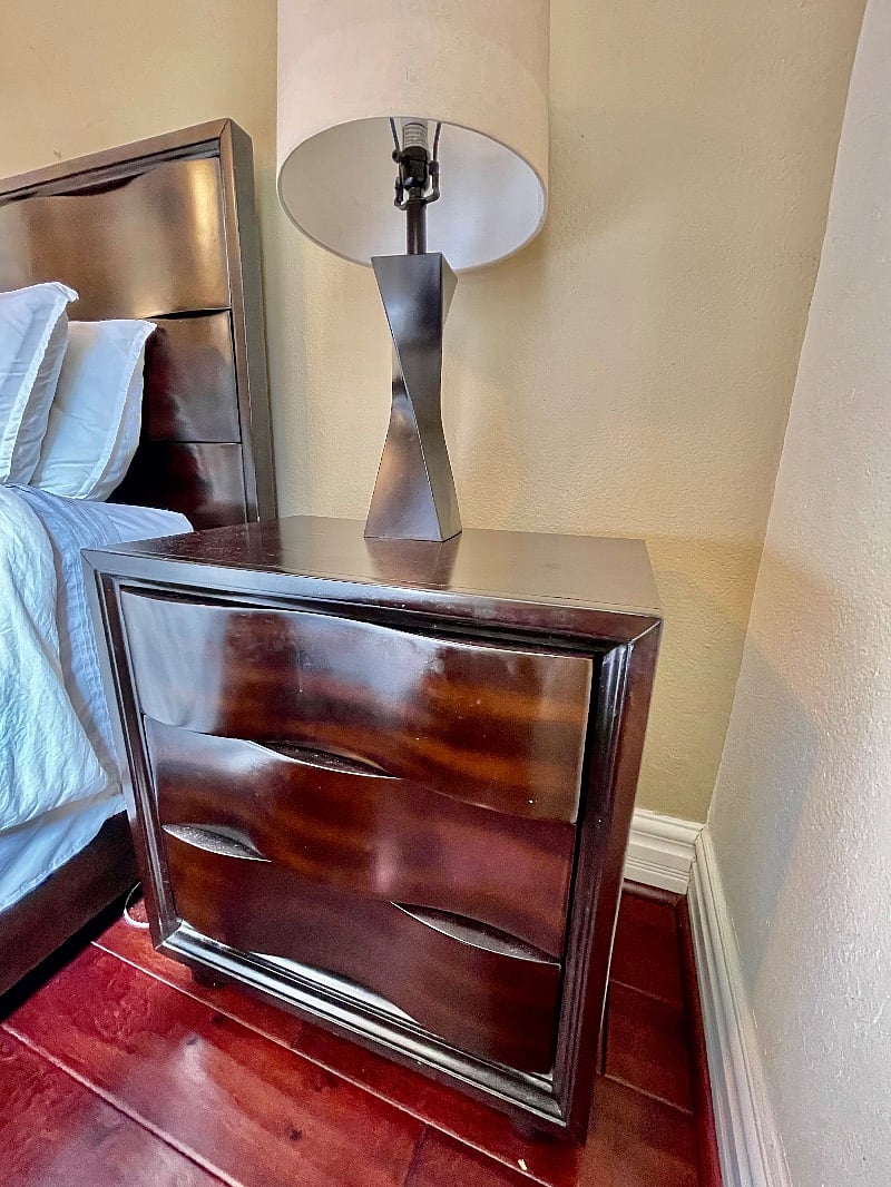 Nightstands with lamps on each side of bed
