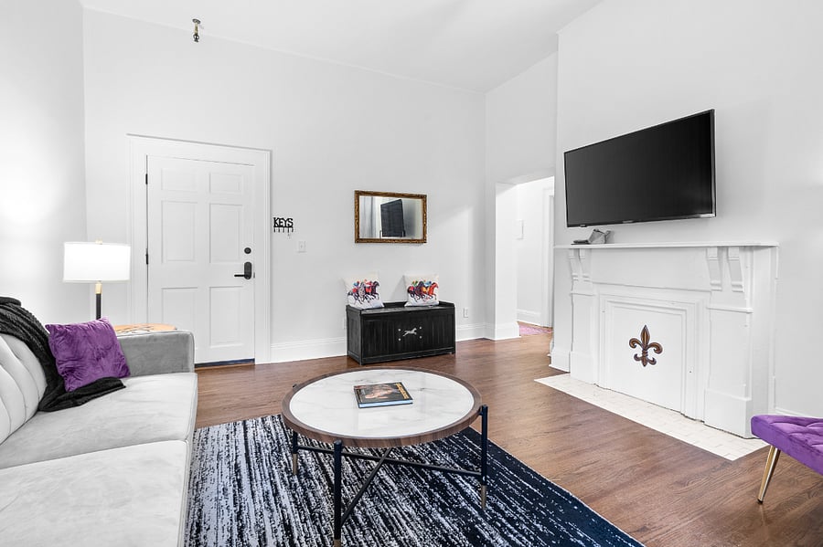 Spacious living room with large windows and 10 ft ceiling to bring in natural light.
