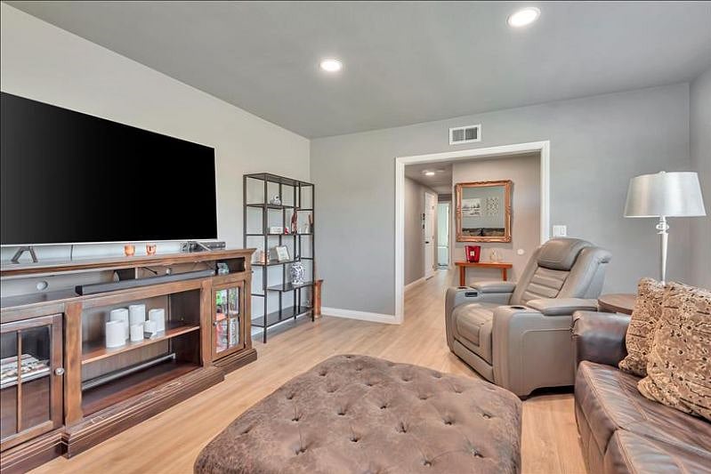 Cozy living room: love seat, queen sofa bed, 65 smart TV, board games.
