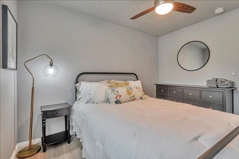 Cozy 3rd bedroom: Queen bed, TV, closet, 8-drawer chest, side table.