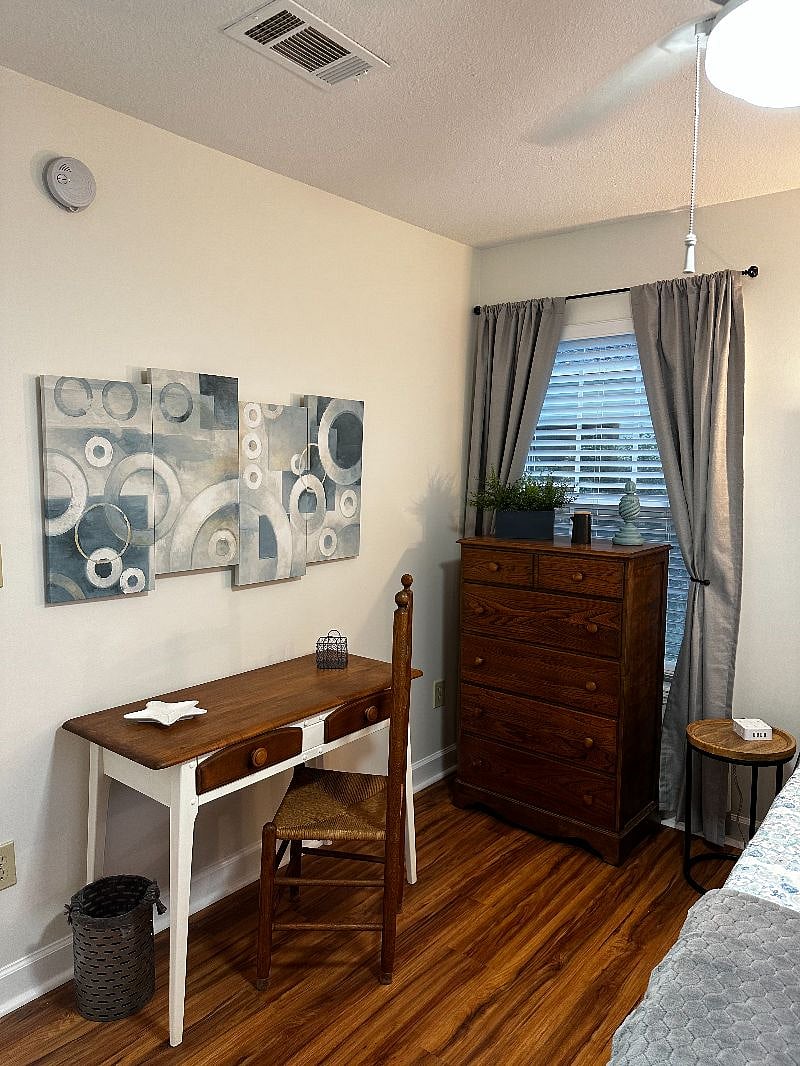 Downstairs bedroom with desk and dresser