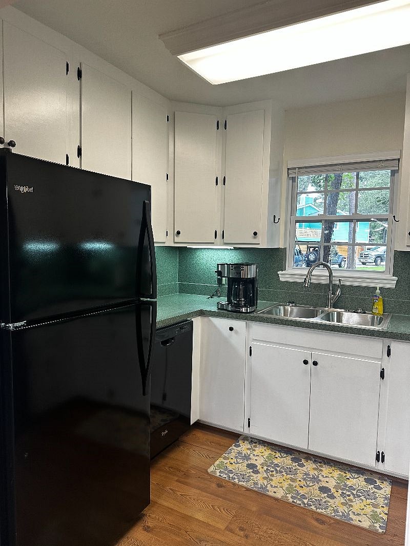 Fully equipped kitchen with electric oven/stove combo, microwave, refrigerator, dishwasher, coffee maker (single pod and full pot combo) and toaster oven.