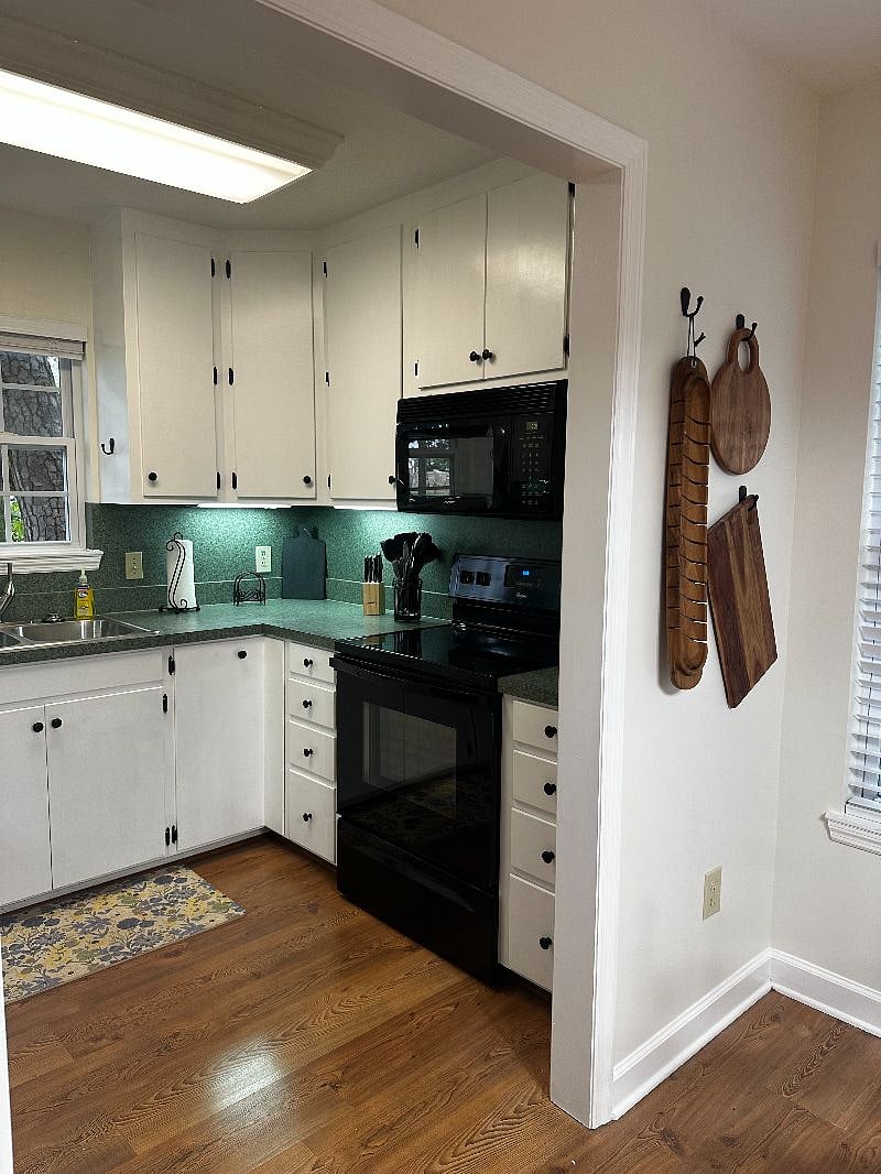 Fully equipped kitchen with electric oven/stove combo, microwave, refrigerator, dishwasher, coffee maker (single pod and full pot combo) and toaster oven.