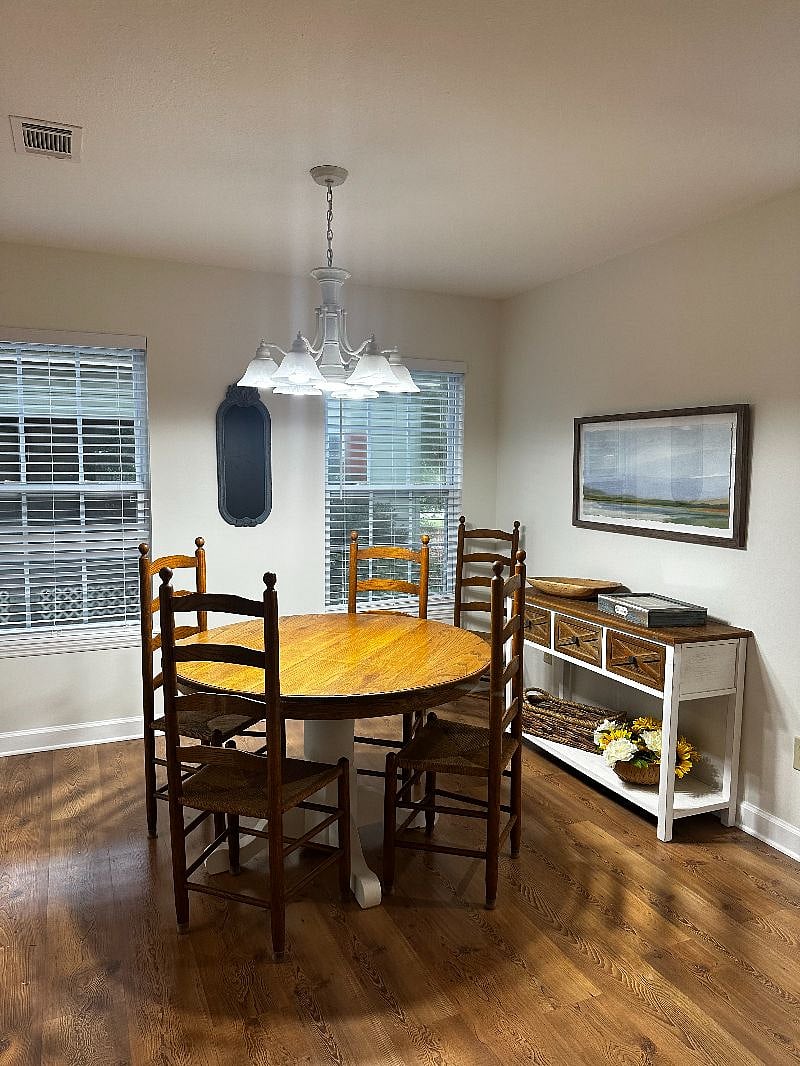 Dining room table for four. There is a leaf and two extra chairs with seating for six.