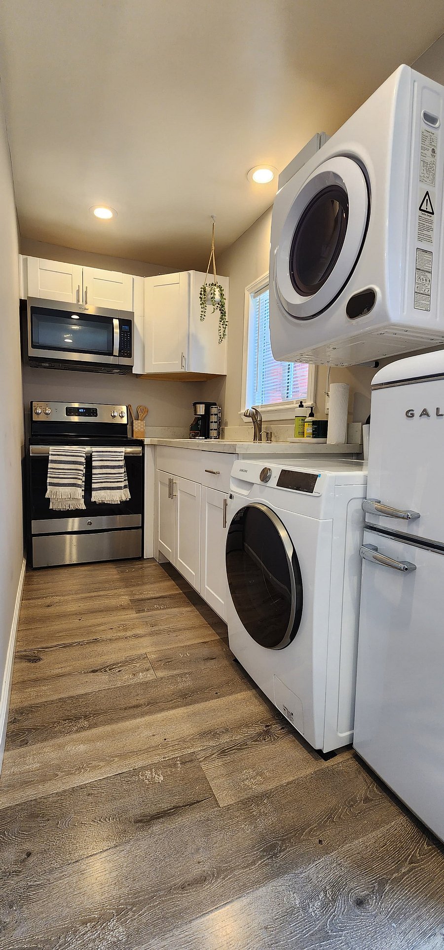 Sleek appliances stand ready to assist you in your culinary endeavors, With excellent water pressure ensuring every task, from rinsing vegetables to laundry, is done with ease, this kitchen is a haven for both cooking and living.