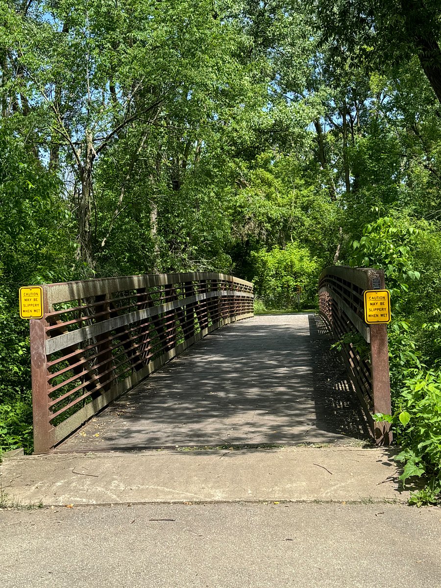 Beautiful Bridge crossing a creek on Bike trail ; less than a mile from our home .