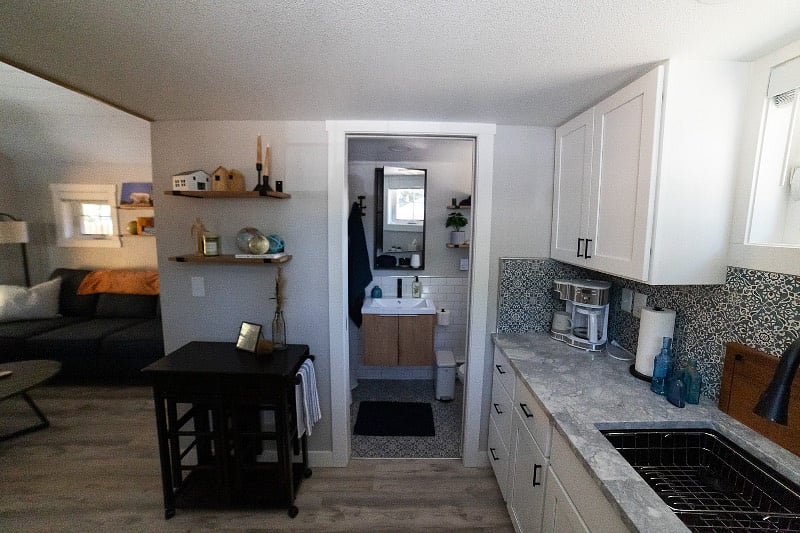 Living area to the left, bathroom center, kitchenette to the right