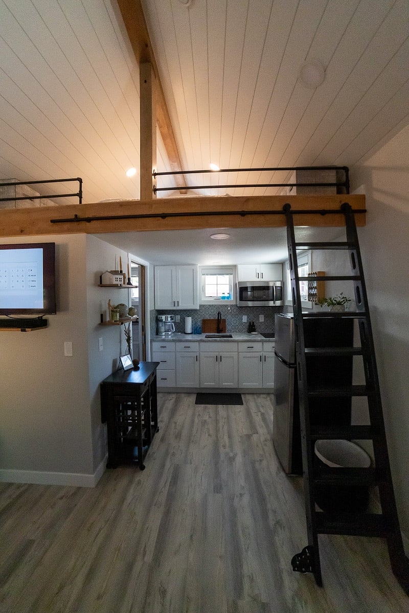 Rolling loft ladder accesses sleeping loft