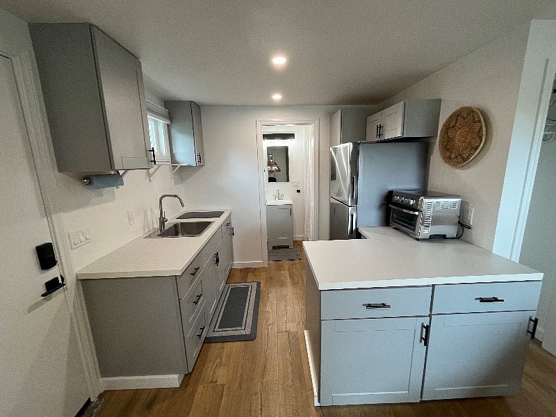 brand new kitchen with full size refrigerator, electric cooktop, microwave, and air fryer/oven