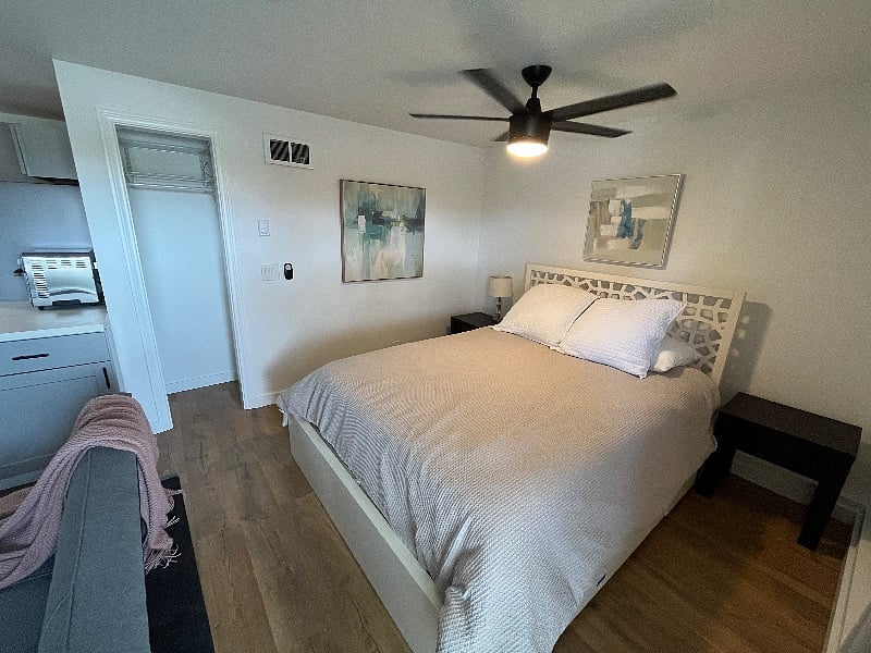 queen size bed with under bed storage drawers. closet with vertical storage