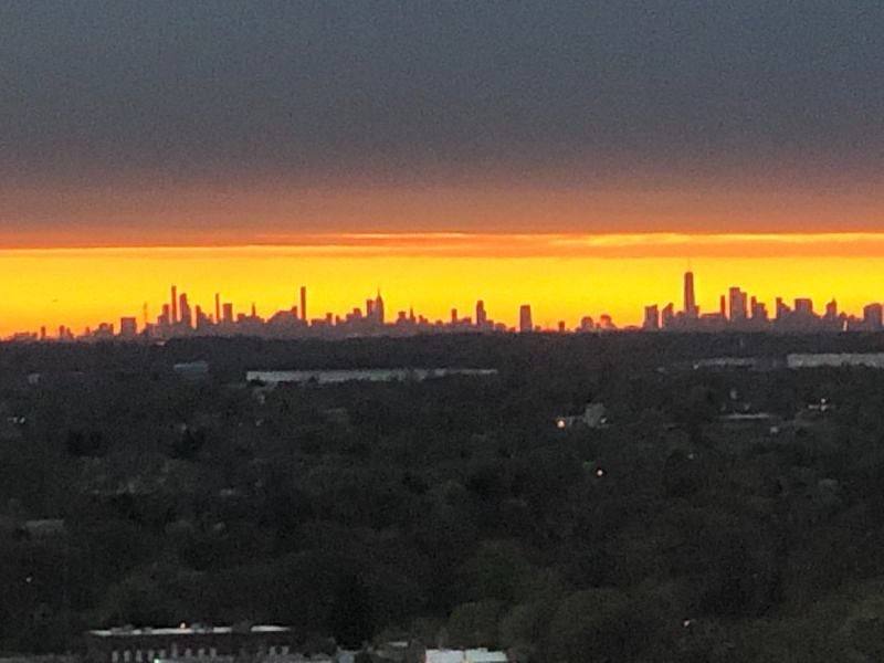 Apartment window view of the NYC skyline.