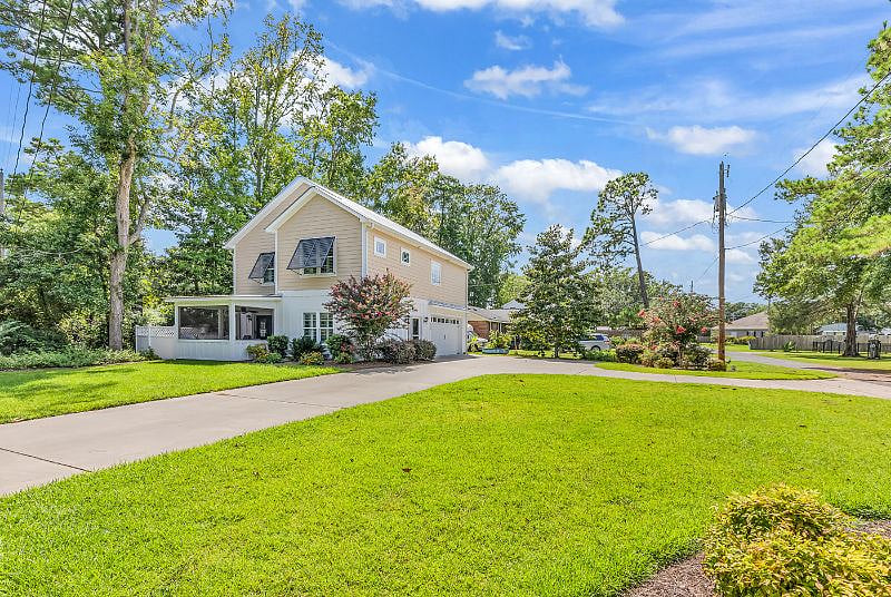 Private raised beach home with attached 2 car garage, fenced backyard and screened in Carolina room. 