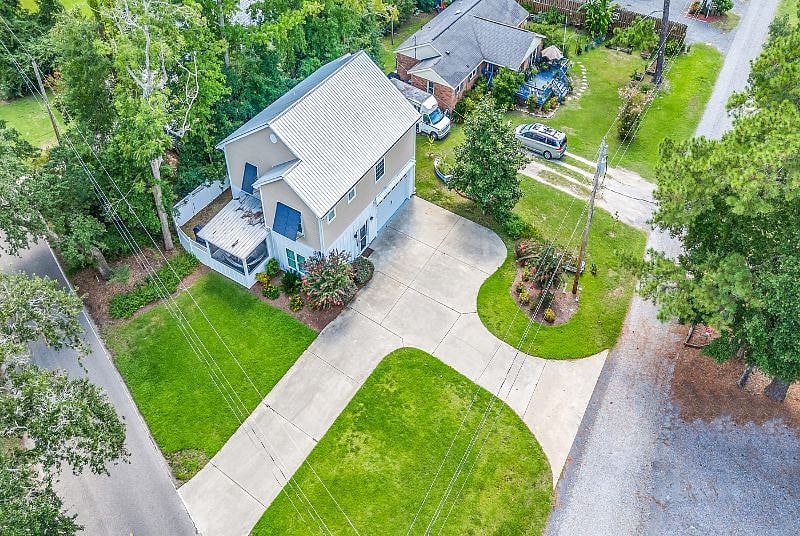 Private raised beach home with attached 2 car garage, fenced backyard and screened in Carolina room. 
