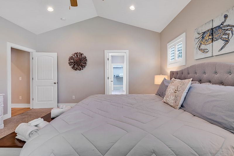 Large primary suite with vaulted ceiling, walk in closet and 5 piece bathroom