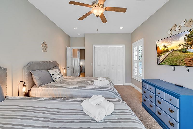 Large bedroom on lower level with lots of windows covered with plantation shutters. Smart TV and 2 Queen beds! Perfect for roommates or guests!