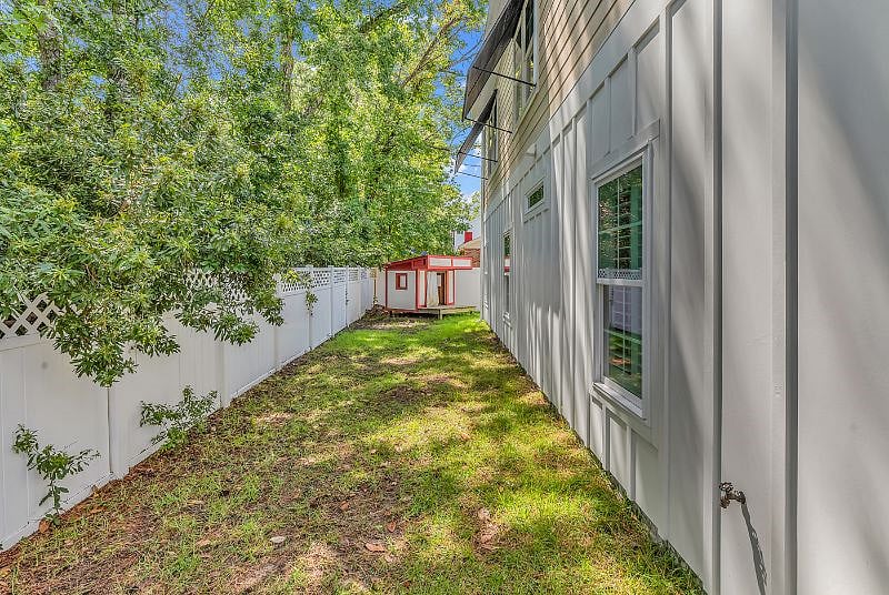 Fully fenced backyard with playhouse 