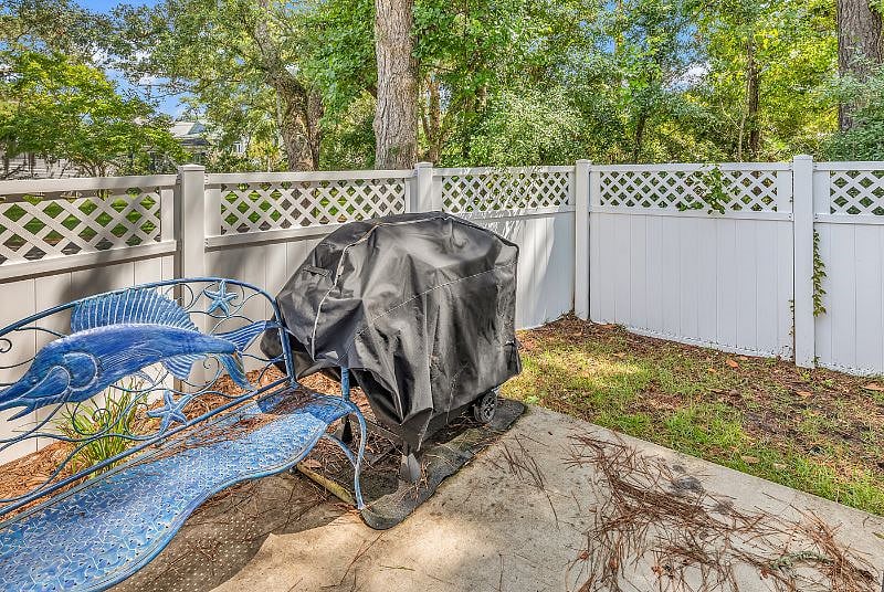 Backyard has patio with propane grill and fire pit.