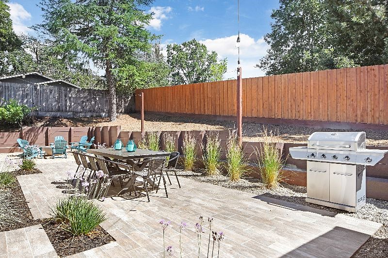 Back Patio with outdoor string lights and large BBQ (with propane tank)