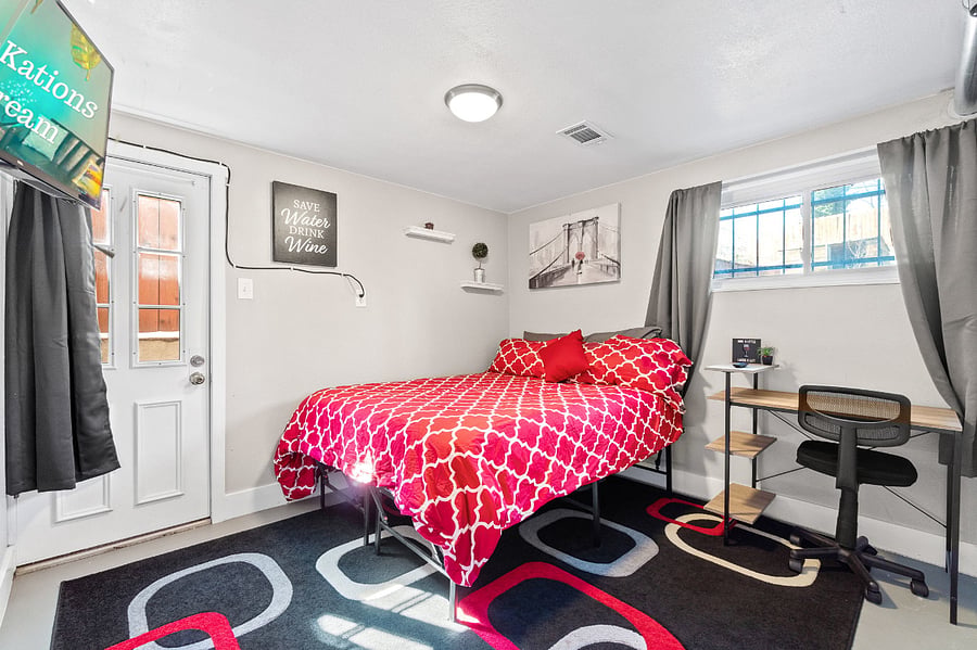 Cozy up in the comfort of a queen-sized bed with Roku TV and a productive computer desk!