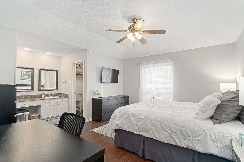 Master (primary) bedroom with king bed, ensuite with walk in shower, large walk in closet, Smart TV and work desk