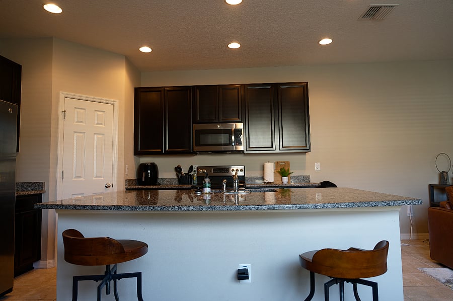 Open Kitchen, with Large Island, stainless steel appliances, large pantry closet.
