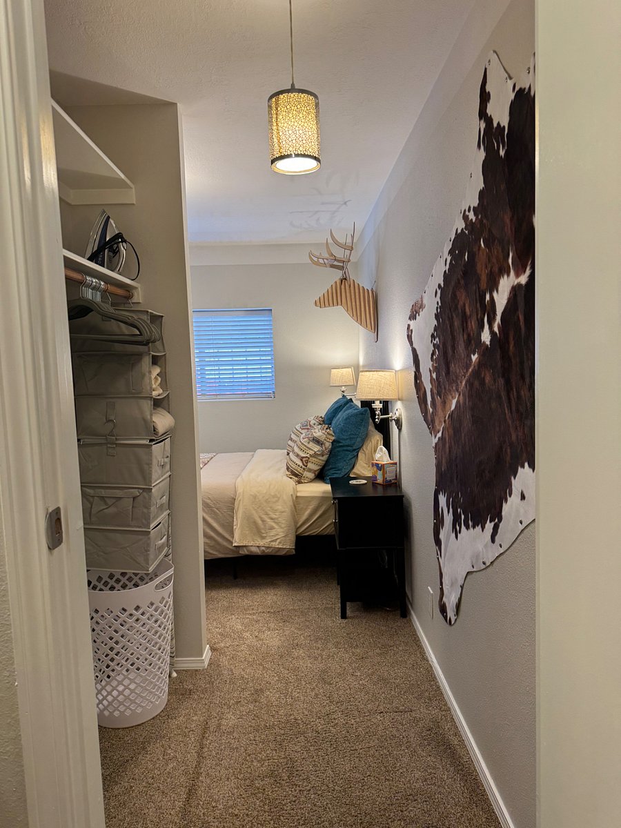 View into bedroom area from bathroom and hall closet.