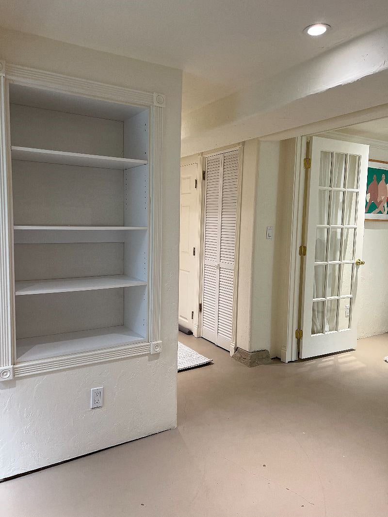 living room built in shelves and hallway view
