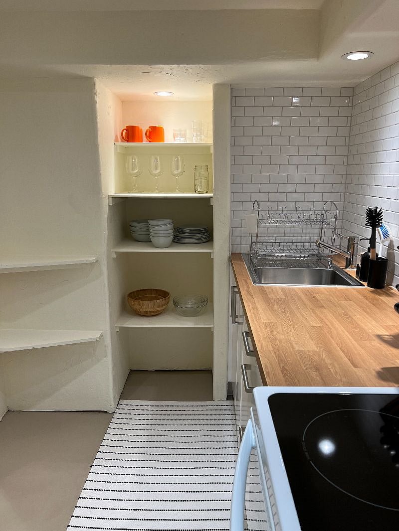 kitchen stocked with lots of cookware & dinnerware
