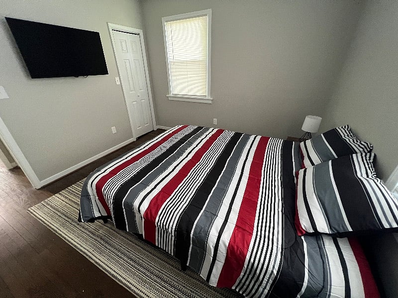 Bedroom number 1 features a comfortably plush queen foam bed, with matching end tables and a 43" LCD TV equipped with Amazon Firestick.