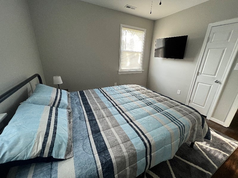 Bedroom number 2 features a comfortably plush queen foam bed, with matching end tables and a 43" LCD TV equipped with Amazon Firestick.