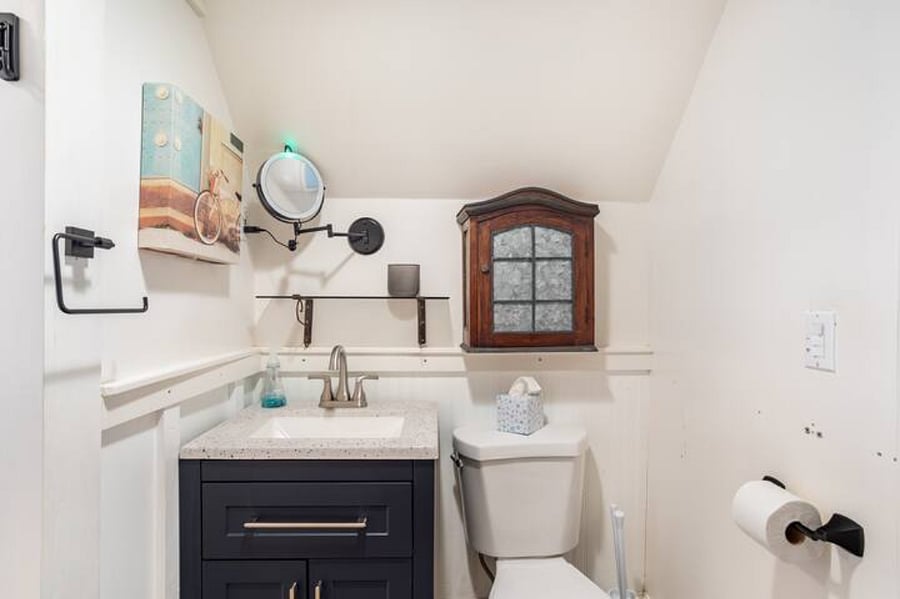 Large open bathroom with sink, vanity, & medicine cabinet on 2nd floor.