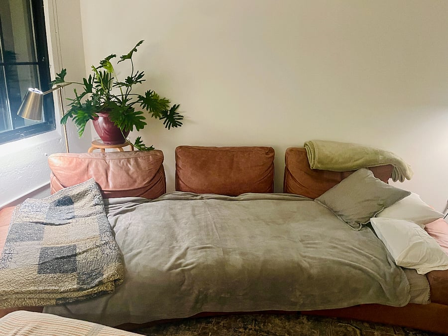 Living room sofa shifts into very deep seating or nice size bed for a very tall person (much longer than a queen but width between a twin and a double)